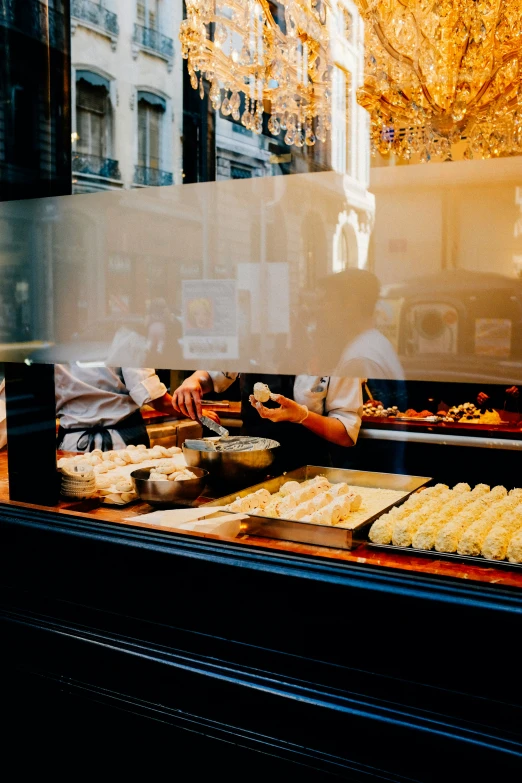 two men are working behind a store front window