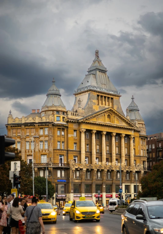 the old city building has a sky line with dark clouds in background