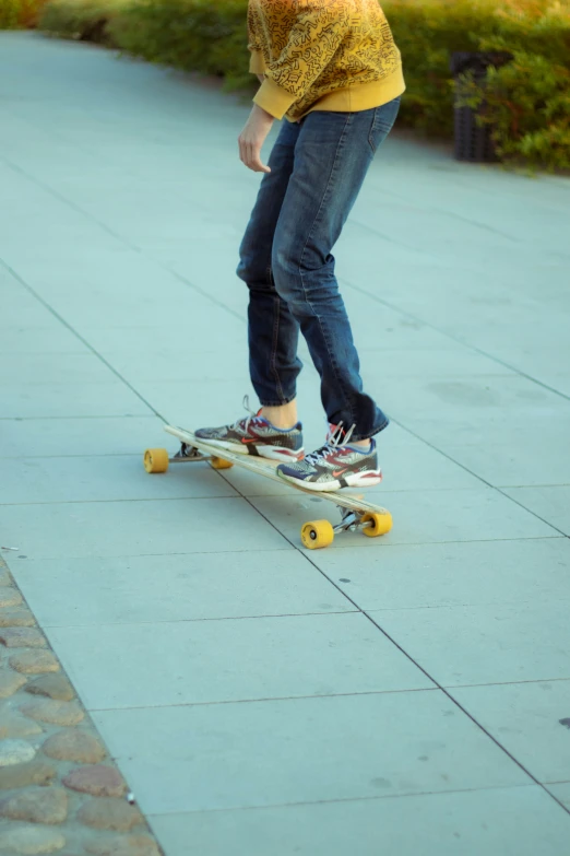 a woman skateboarding on a cement pathway