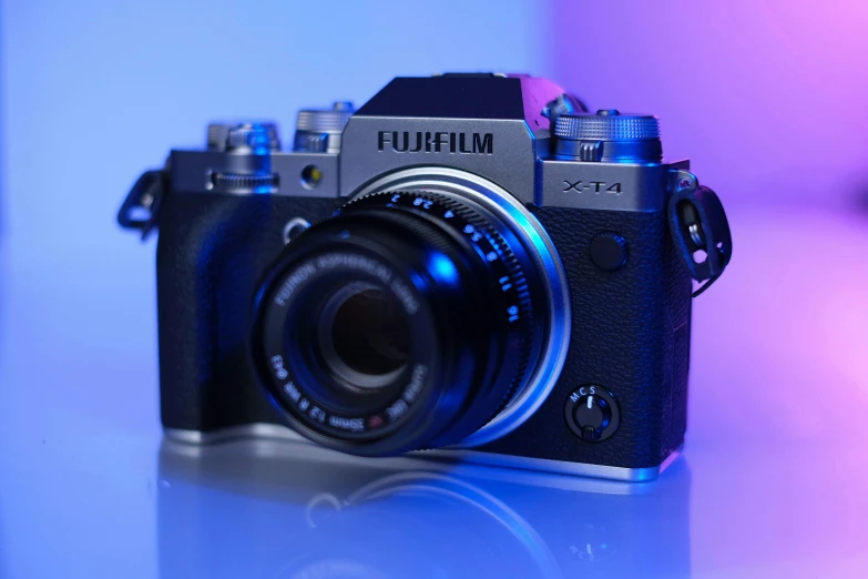 a black camera with a bright light blue back