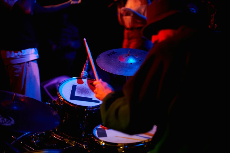 a group of people playing drums and drums on stage