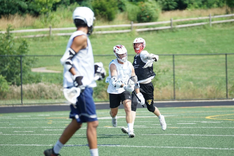 the lacrosse team runs to get control of the ball