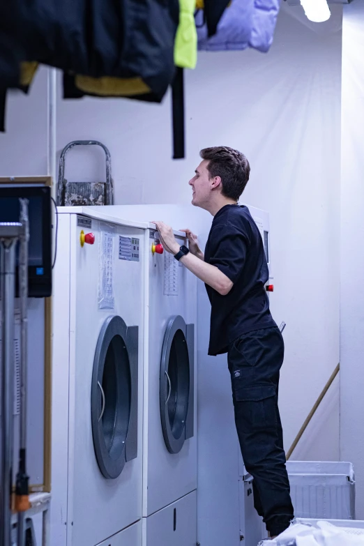 a man is hing soing off a washer