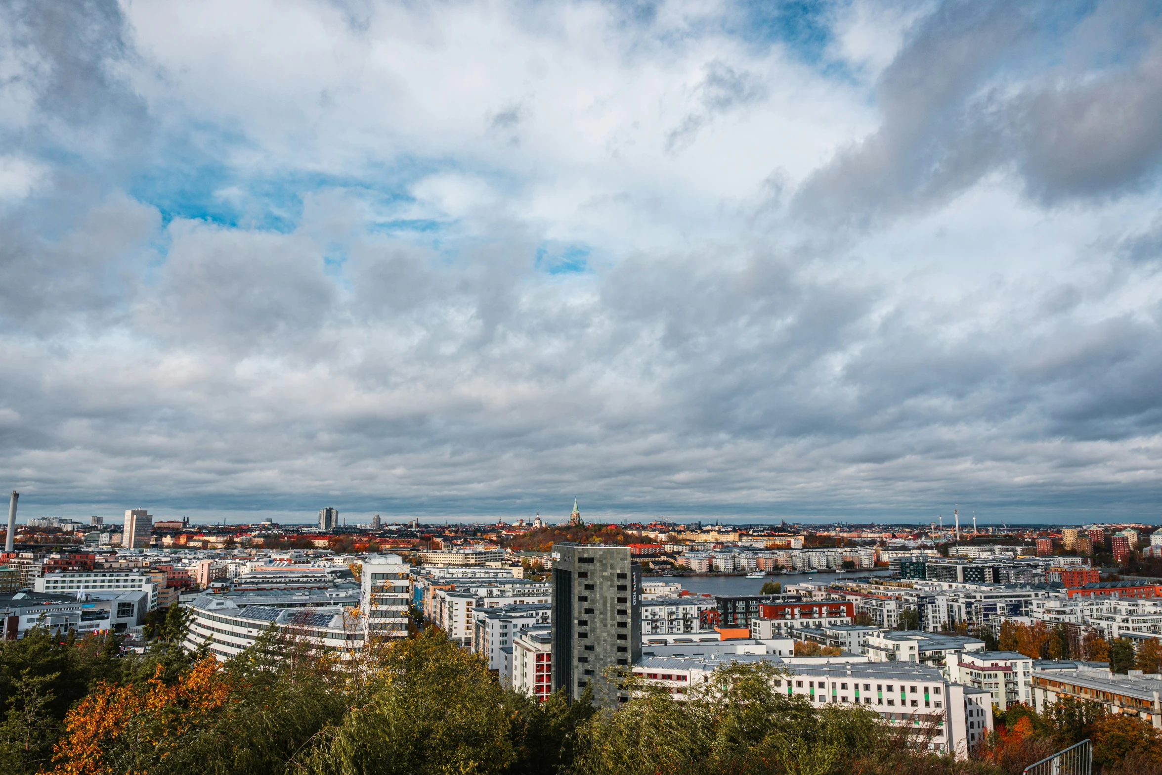 a city view from atop a hill looking at the sky