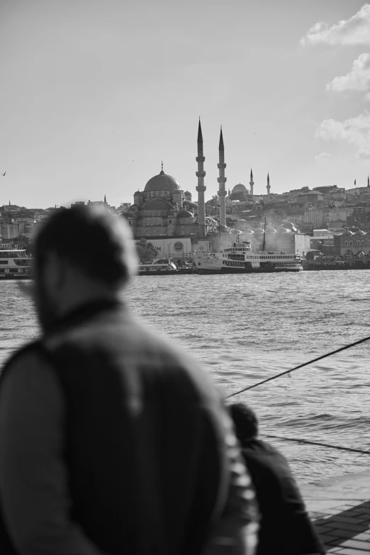 two people standing near a body of water while on board