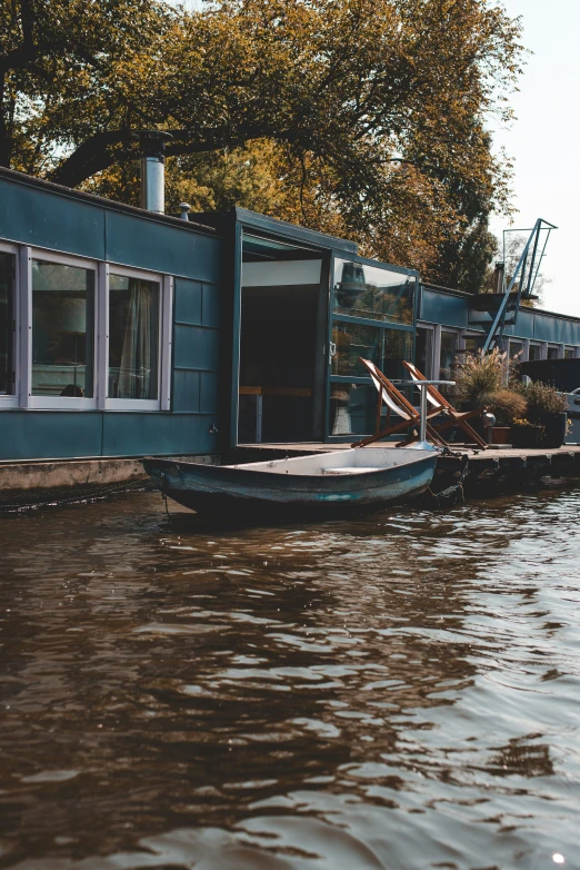 the houseboat is parked in the river, with its door open