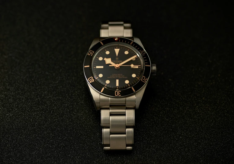 a watch on a black background that is lit up