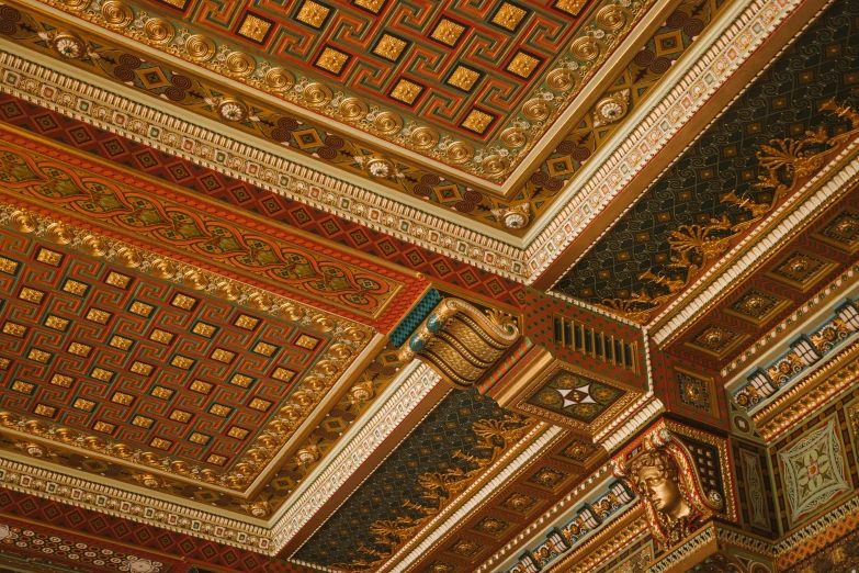 an elaborate ceiling with a gold and red design