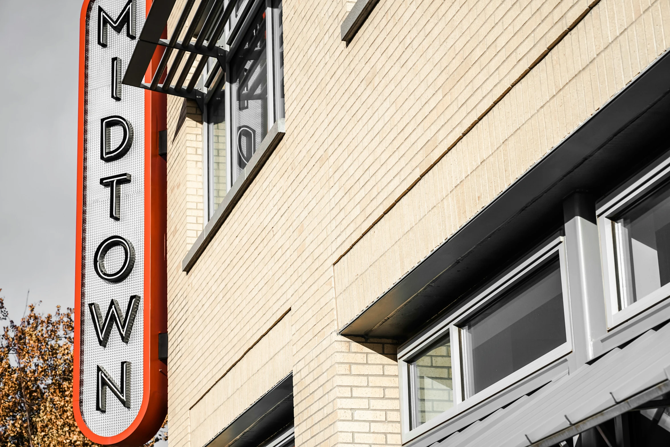 a theater sign on the side of a brick building