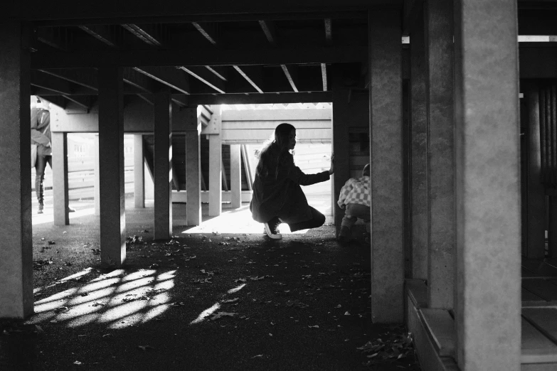 black and white image of a woman walking in an enclosure