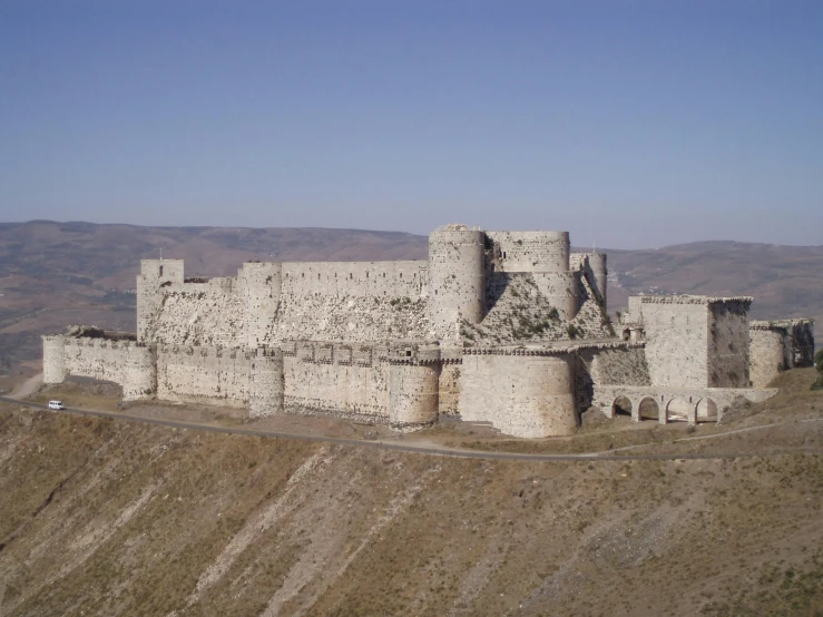 an old brick castle on a hill top