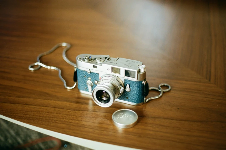 an old fashioned camera sitting on a wooden table