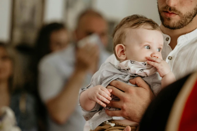 a father holding his baby in his arms