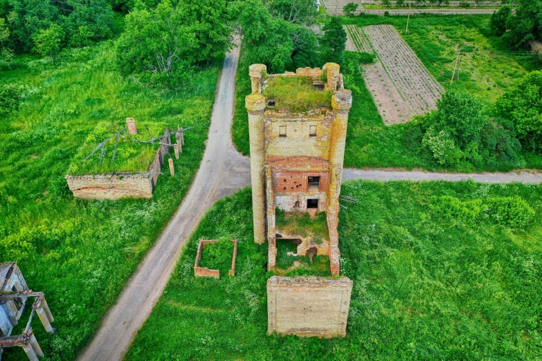 an aerial s of the ruins of a building and road