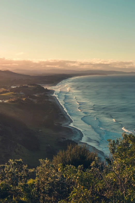 the sun shines on a scenic coastline