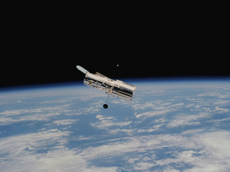 the space shuttle is suspended over earth