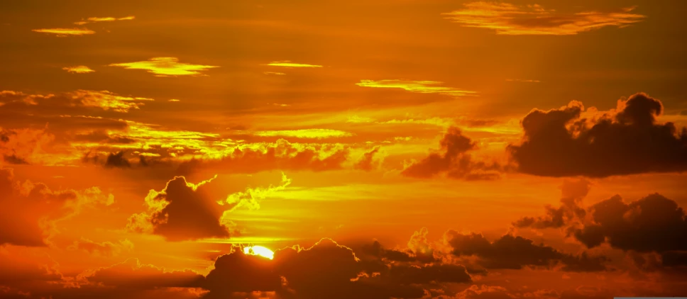 the sky is beautiful during sunset with a yellow and orange colored pattern