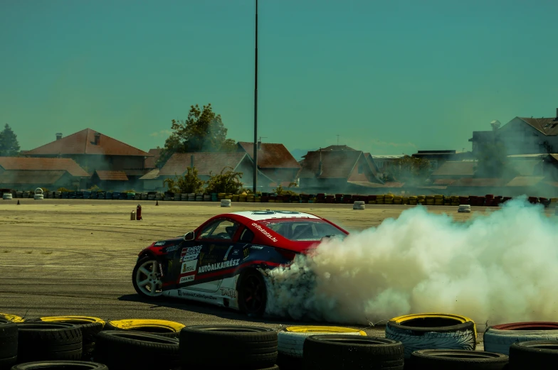 a red car spinning around with its wheels on the side