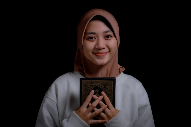 a woman holding a book in front of her face