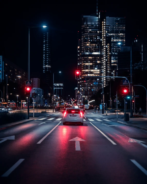 a city street at night with traffic lights