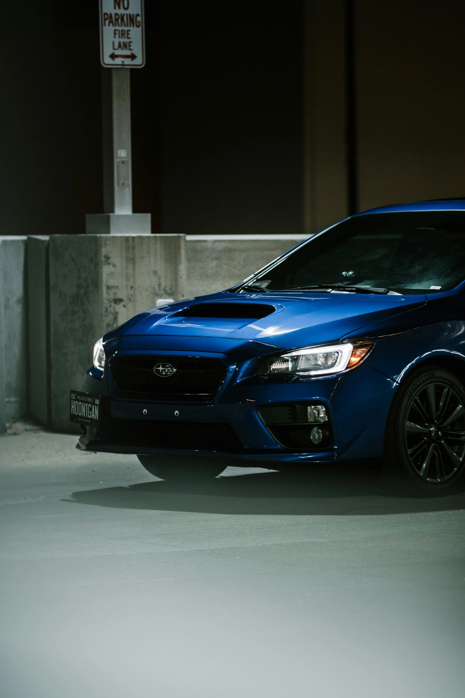 a blue car is parked by some concrete