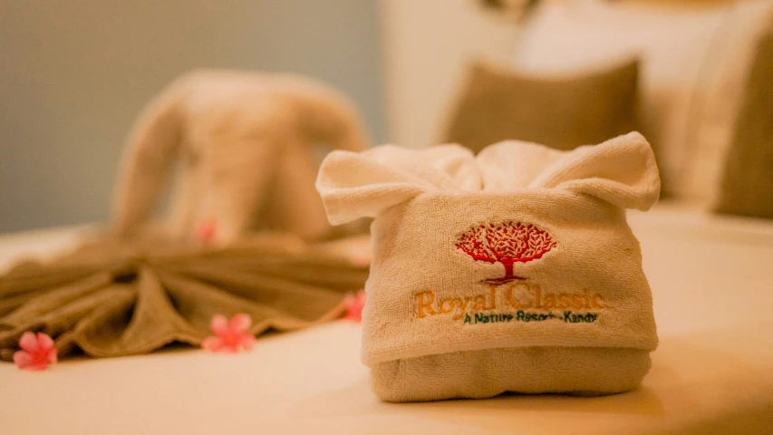 towel folded on table with a logo on it