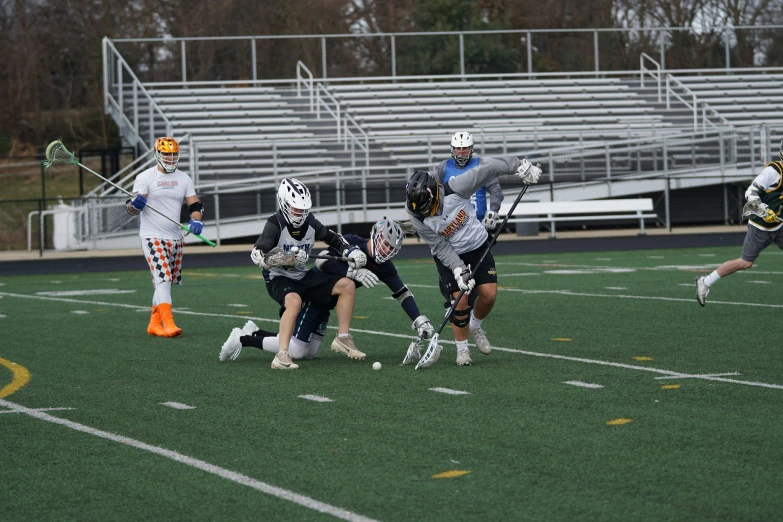 the lacrosse players are trying to grab the ball