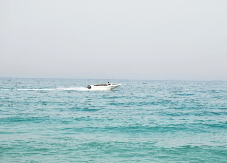 a motorboat riding across the ocean with no people