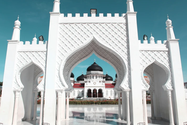 a building with arches and pillars near water