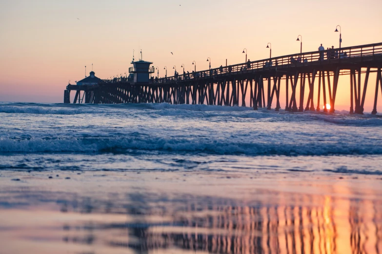 the end of a long pier at sunset