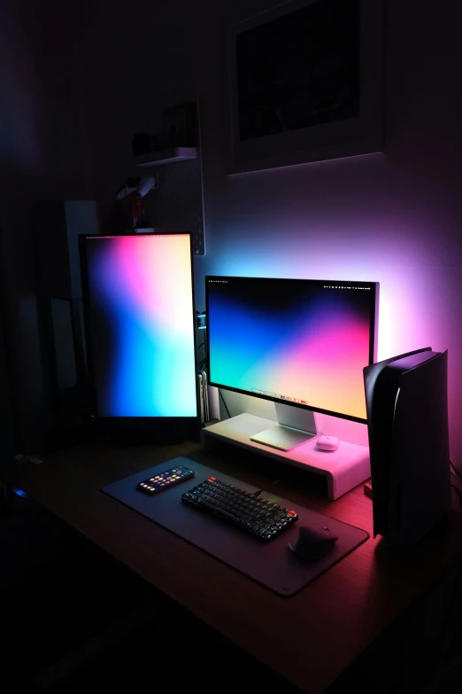 a computer and a keyboard lit up on a desk