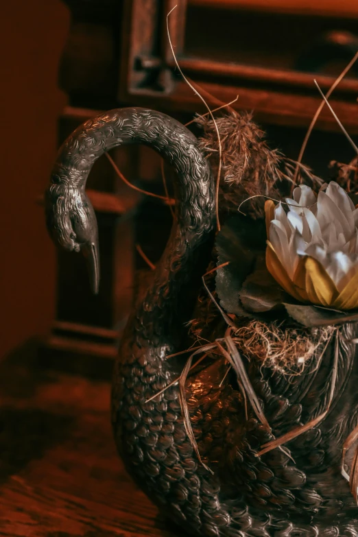 a decorative ceramic swan is shown on a table