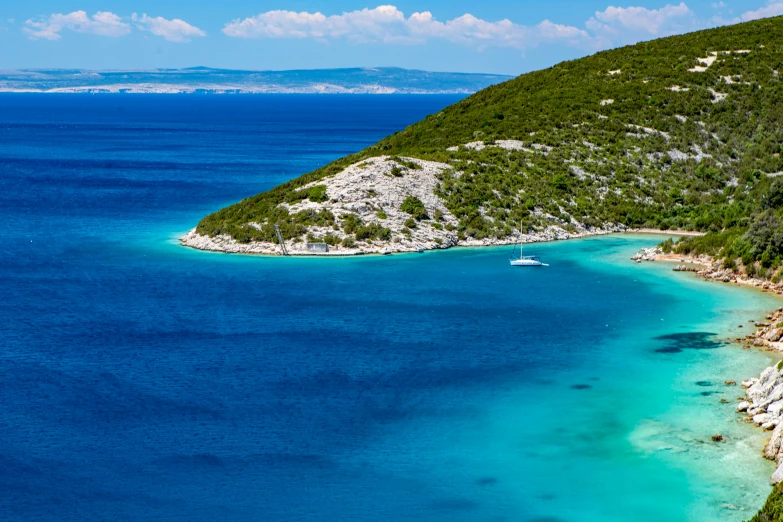 some boats sailing in the clear blue water