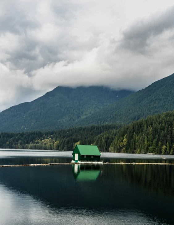 a boat sits on a lake near the mountains