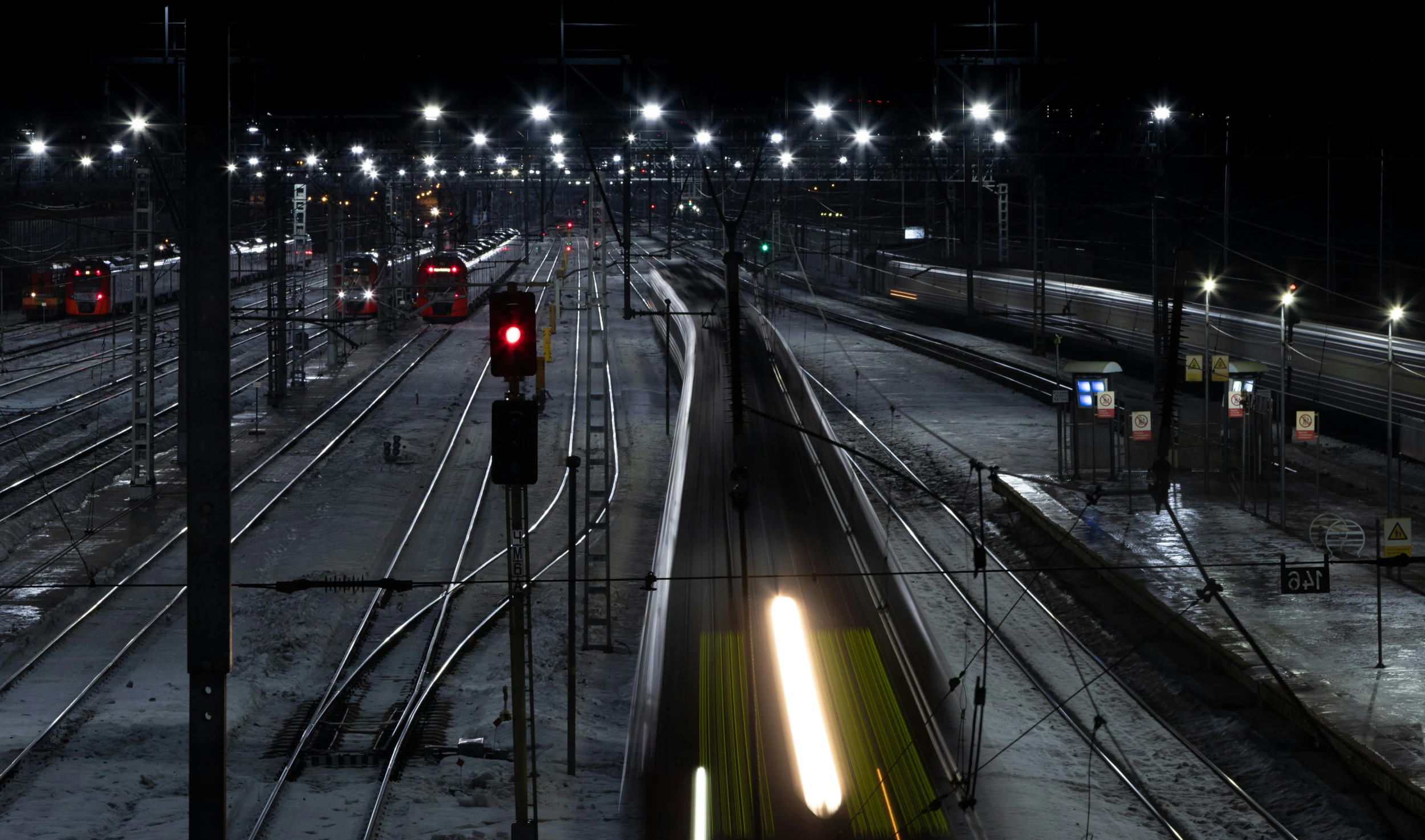 several trains on a rail yard at night time