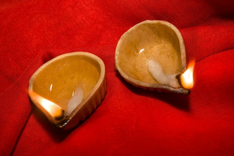 two small brown pots that are in a bowl