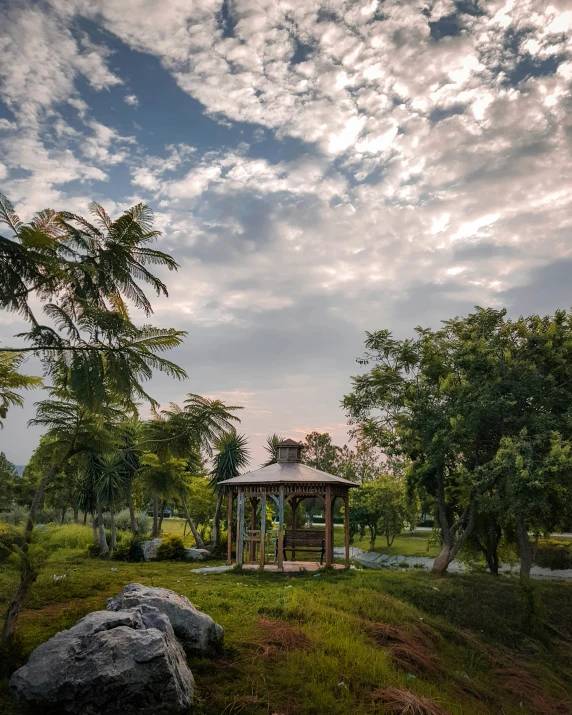 a bench and stone structure in the park