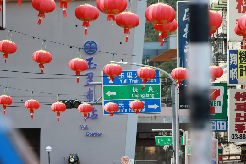 a bunch of red chinese lanterns on a street