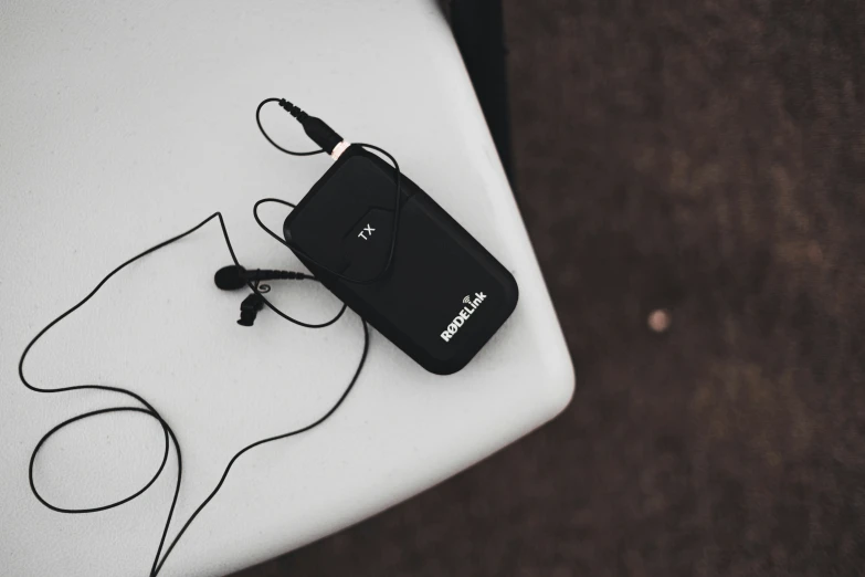 a small black camera with a cord plugged in