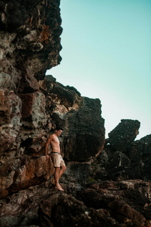 a man is on top of a rock wall