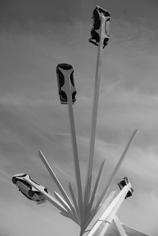 the lights are lit on poles under a cloudy sky