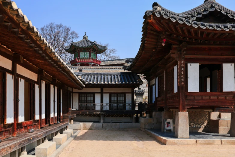 an oriental courtyard is lined with wooden framed windows