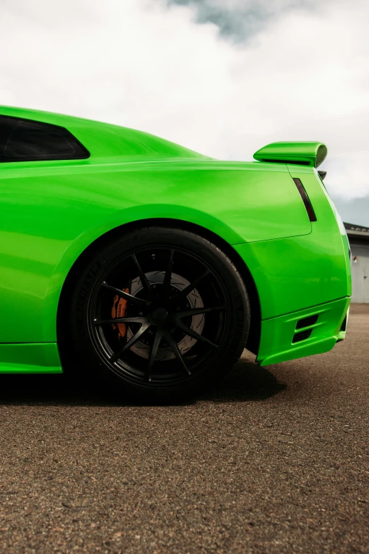 a lime green sports car is parked near a barn