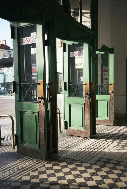 a couple of doors are open on a sidewalk