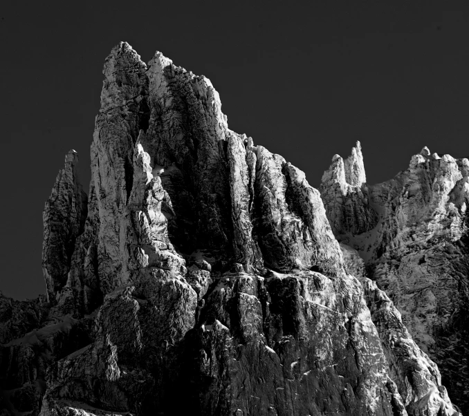 a black and white po of mountains under a clear sky