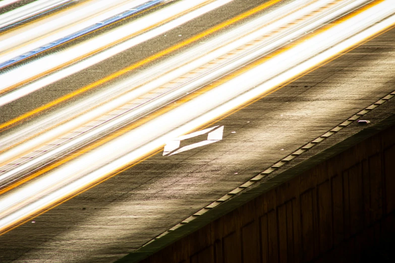 a highway with stripes on the side and yellow lines behind it