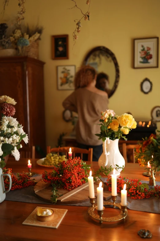 a table with some flowers in a vase on it