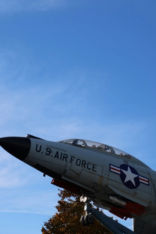 an airplane is sitting in the sky with a sky background