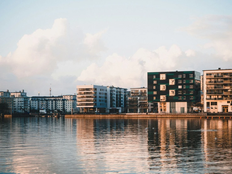 buildings reflected in a still body of water