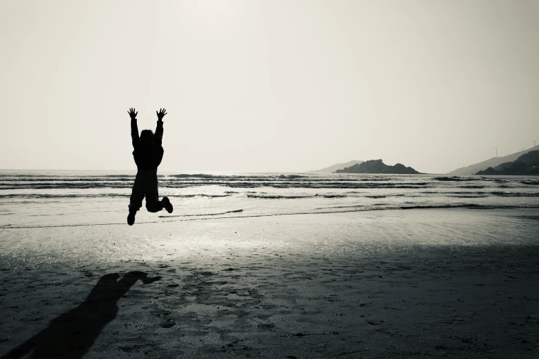 a black and white po of a person jumping in the air